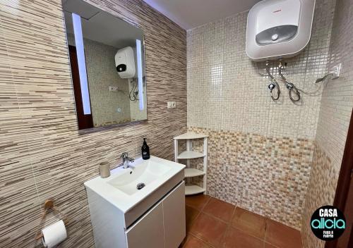 a bathroom with a sink and a mirror at Casa Alicia - El Cotillo - 2 Camere, 2 Bagni in El Cotillo