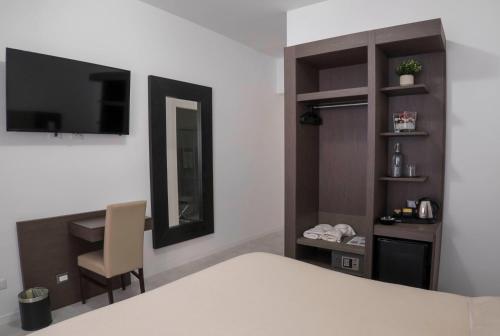 a bedroom with a bed and a desk and a mirror at Il Perugino Guest House in Rome