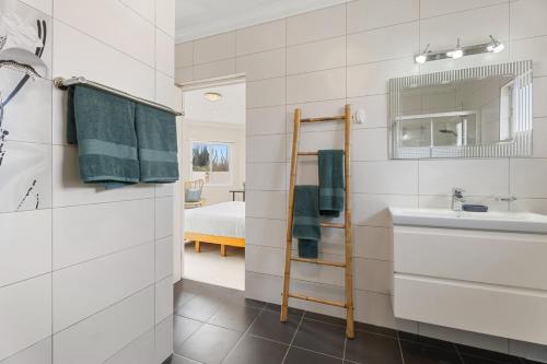 a bathroom with a sink and a mirror at NEW 3BR 2BA Private Villa with Spacious Garden in Noord
