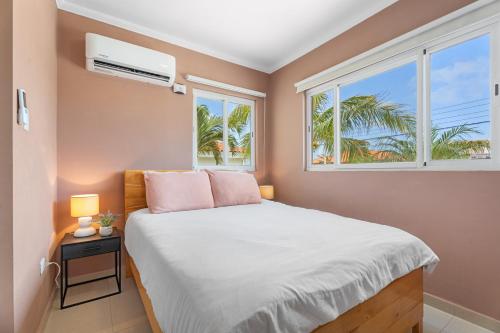 a bedroom with a bed and a window at NEW 3BR 2BA Private Villa with Spacious Garden in Noord