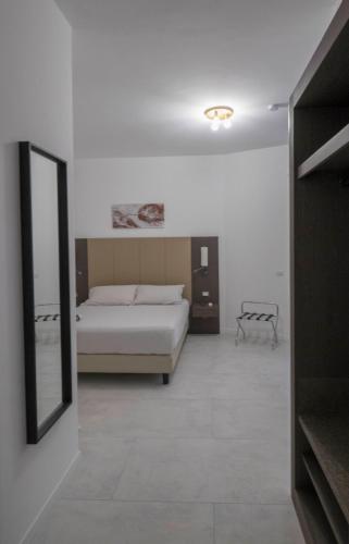 a bedroom with a bed and a mirror at Il Perugino Guest House in Rome