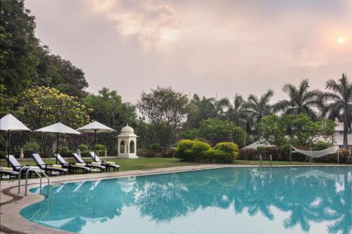 a swimming pool with lounge chairs and a gazebo at Gateway Aurangabad - Chhatrapati Sambhaji Nagar in Aurangabad