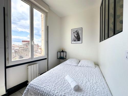 une chambre blanche avec un lit et deux fenêtres dans l'établissement Studio cosy, à Agen