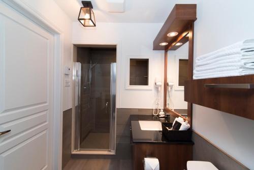 a bathroom with a sink and a shower at Luxurious mountainside condo - Ski-Waterslide - Domaine Nymark in Saint-Sauveur-des-Monts