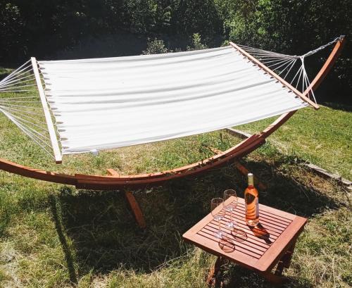 a picnic table with a bottle of beer on it at Maison d'Hotes du Vert Vallon in Theizé