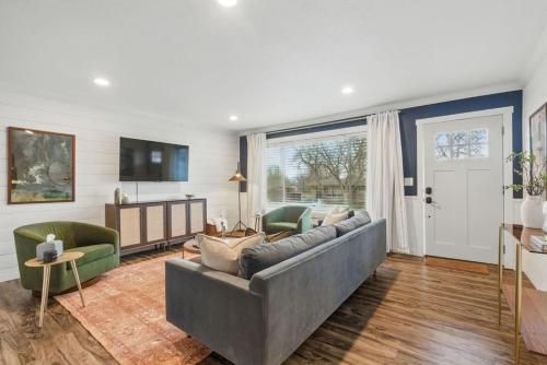 a living room with a couch and a tv at Projector Nights And Park Delights Designer Reno in Arvada