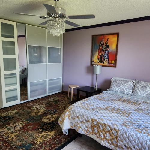 a bedroom with a bed and a painting on the wall at Hilltop Hacienda in San Marcos