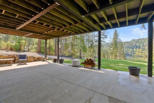 an empty patio with a view of the mountains at The CDA-frame - Lake Views with Boat Slip in Coeur d'Alene