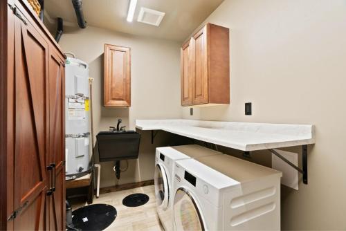 a kitchen with a washing machine and a sink at The CDA-frame - Lake Views with Boat Slip in Coeur d'Alene