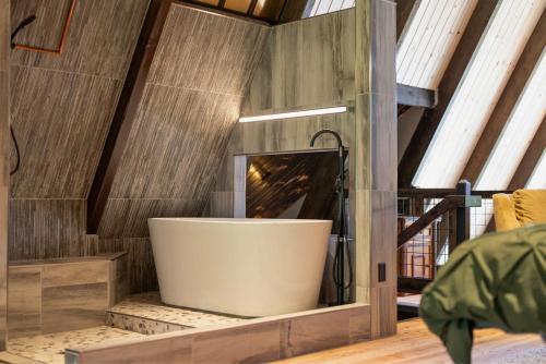 a bath tub in a room with a fireplace at The CDA-frame - Lake Views with Boat Slip in Coeur d'Alene
