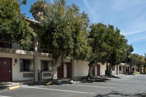 a row of trees in front of a building at Mission Inn in Santa Cruz