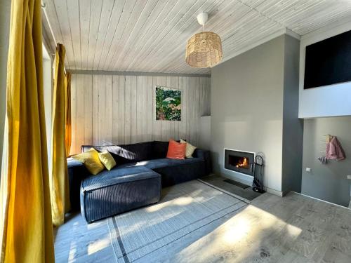 a living room with a couch and a fireplace at Sunny family holiday home in Jurmala in Jūrmala