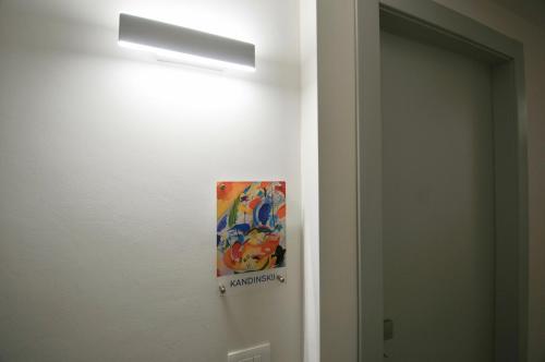 a painting on a wall next to a door at Agrigento Luxury Suite Kandinskij in Agrigento