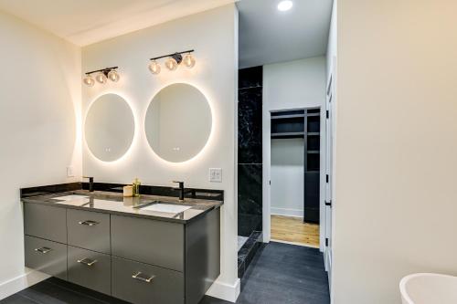 a bathroom with a sink and a mirror at Spacious Deck Contemporary Home in Nashville! in Nashville