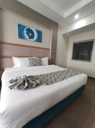 a bedroom with a large bed in a room at Hotel Grand Eureka Near Delhi Airport in New Delhi