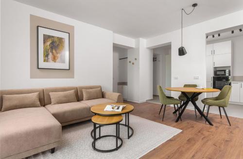 a living room with a couch and a table at Hubix Suites - City of Mara in Timişoara