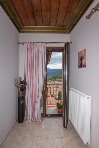 a room with a door open to a balcony at Atrapos in Karpenision