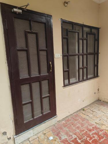 an open door and a window on a wall at Hillside Haven near Kainchi Dham in Bhowāli