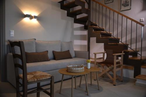 a living room with a couch and a table at Stone Hut Apartments in Ayios Nikolaos Sithonia