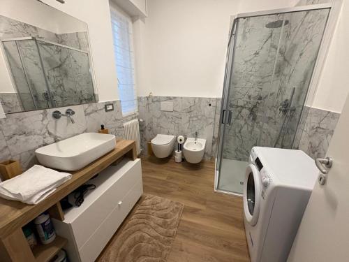 a bathroom with a sink and a toilet and a shower at Focolare Manzoni in Lecco
