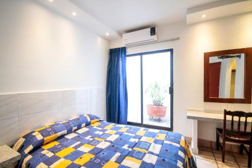 - une chambre avec un lit, une fenêtre et une table dans l'établissement Hotel Arboledas Industrial, à Guadalajara