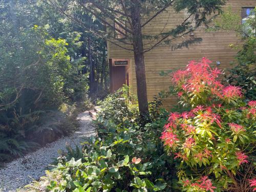 a garden with flowers in front of a building at Hyphocus Inn in Ucluelet