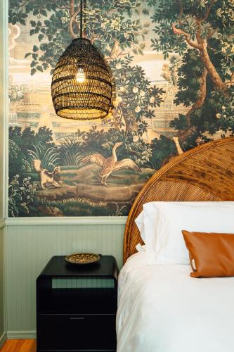 a bedroom with a large tapestry on the wall at Swank Boutique Suites in Ashland