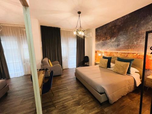 a bedroom with a large bed and a living room at Le Sciantose Relais in Naples
