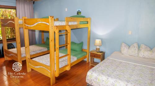 a bedroom with two bunk beds and a bed at Rio Celeste Dreams in Bijagua