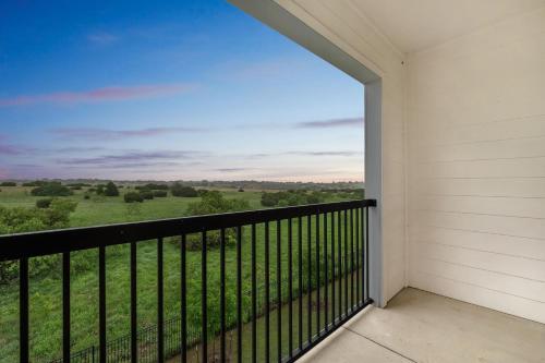 a balcony with a view of a green field at Chisholm Trace 734 I Spacious 1 Bed 1 Bath in Cleburne