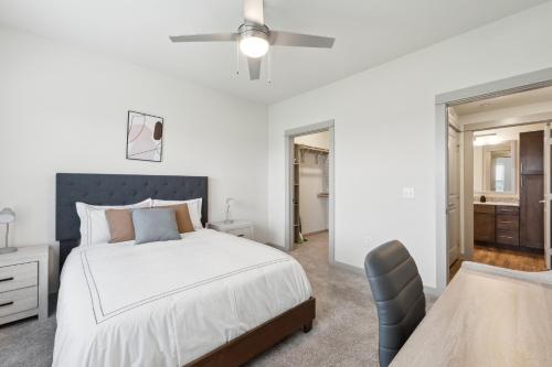 a white bedroom with a bed and a ceiling fan at Chisholm Trace 734 I Spacious 1 Bed 1 Bath in Cleburne