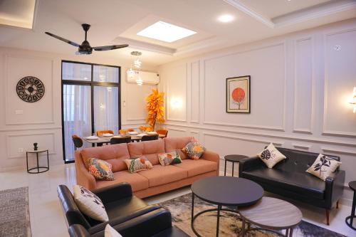 a living room with a couch and a table at Mirpur Modern Spanish Villa - Elegant Comfort in the Heart of the City in New Mīrpur