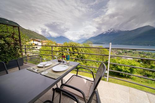 a table and chairs on a balcony with a view at Bed and Breakfast Studios Alto lago di Como in Gravedona