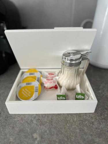 a white drawer with a jar of food in it at Brillante Apartament in Floreşti