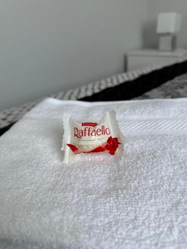 a packet of nirbetilla sitting on a bed at Brillante Apartament in Floreşti