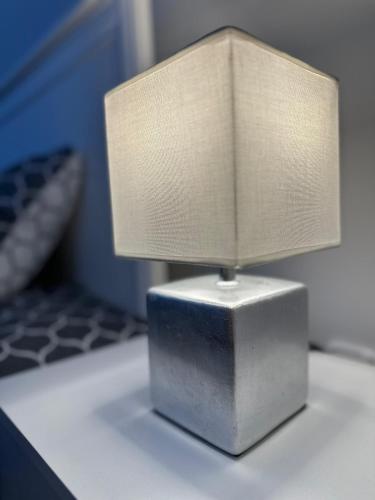 a lamp sitting on top of a table at Brillante Apartament in Floreşti
