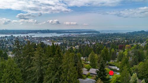 an aerial view of a city with trees and a lake at Seymour Private Bedroom, Ensuite Bathroom with Shared Pool, Hot Tub with Views in North Vancouver