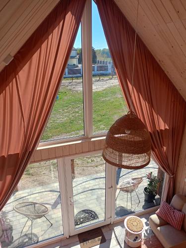a large window with a view of a patio at Mazurskie Stodoły in Piecki