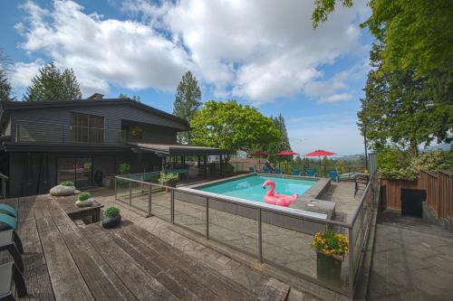 a swimming pool with a pink swan in a yard at The Lions Self Contained Suite, Shared Pool, Hot Tub, Views in North Vancouver