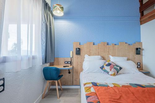 a bedroom with a bed and a blue wall at Sure Hotel by Best Western Mougins Belvedere in Mougins