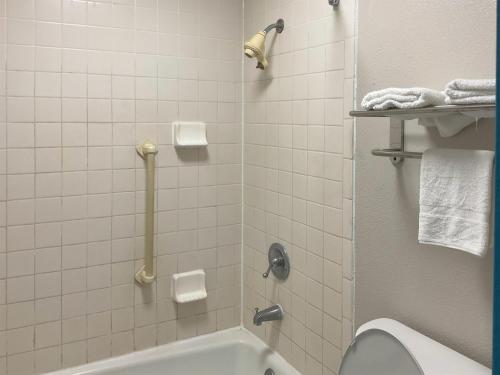 a bathroom with a shower with a toilet and a sink at Motel 6 Baton Rouge East, LA I12 in Baton Rouge