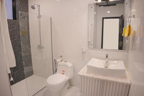 a bathroom with a toilet and a sink and a shower at Mirpur Modern Spanish Villa - Elegant Comfort in the Heart of the City in New Mīrpur