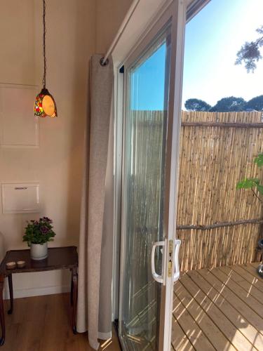 a sliding glass door to a balcony with a view at Matar baYaar מטר ביער in El-Rom