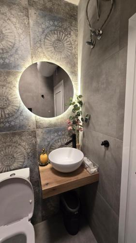 a bathroom with a sink and a mirror at Studio79 in Plovdiv