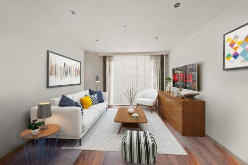 a living room with a white couch and a table at SG, Charming Chelsea Balcony Suite in London