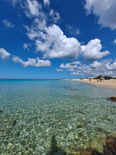 a view of a beach with crystal clear water at Villa Mele in Lido Marini