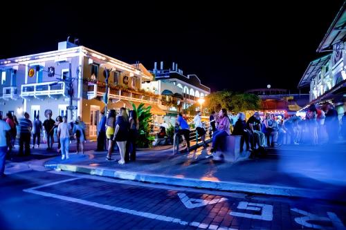 a group of people on a city street at night at The Lofts At Santurce in San Juan