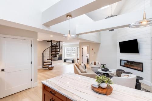 a kitchen and living room with a table and a living room at The Newport Lofts - 543 Thames Street in Newport