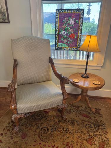a chair and a table with a lamp next to a window at Ozark Country Inn in Mountain View