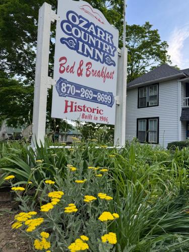 a sign for a bed and breakfast in front of a house at Ozark Country Inn in Mountain View